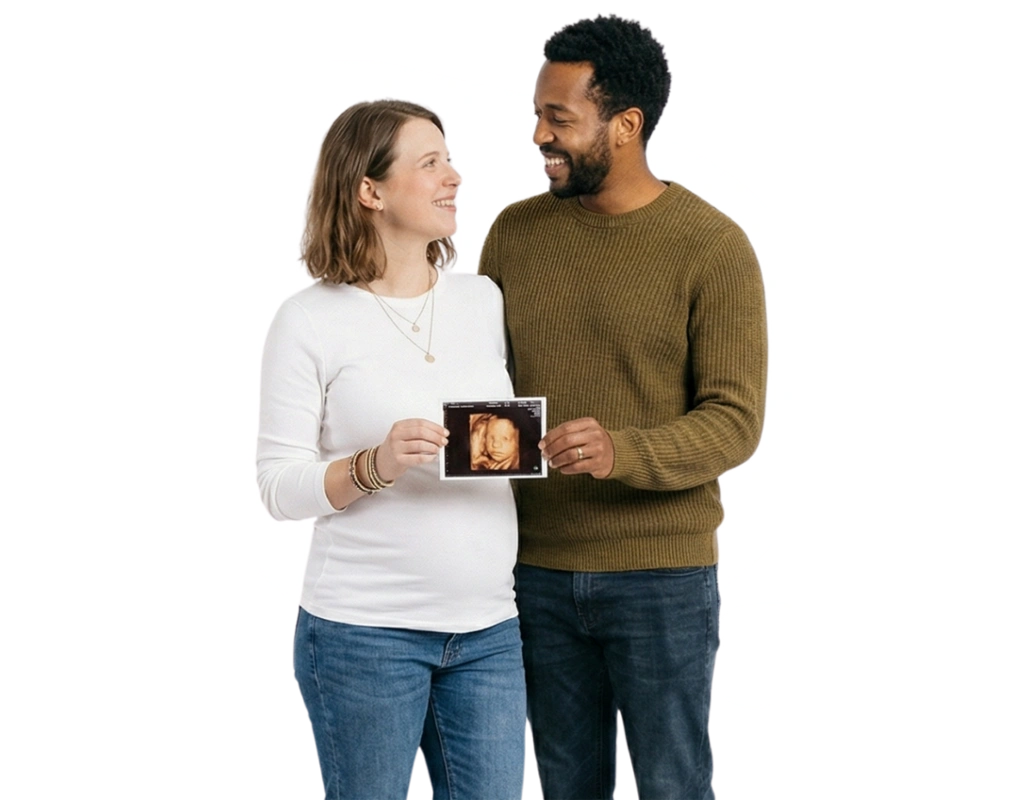 Smiling couple holding their 4D baby scan photo